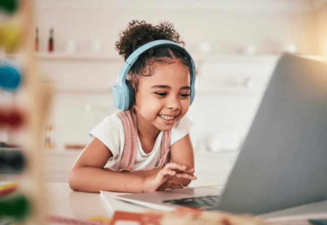 homework and study space girl smiling at computer